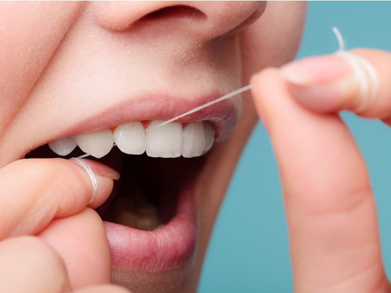 Dental floss, person flossing their teeth