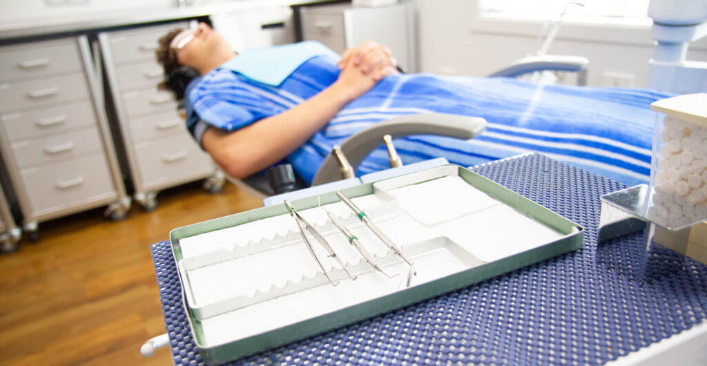 Sleep dentistry, patient in dental chair under dental sedation