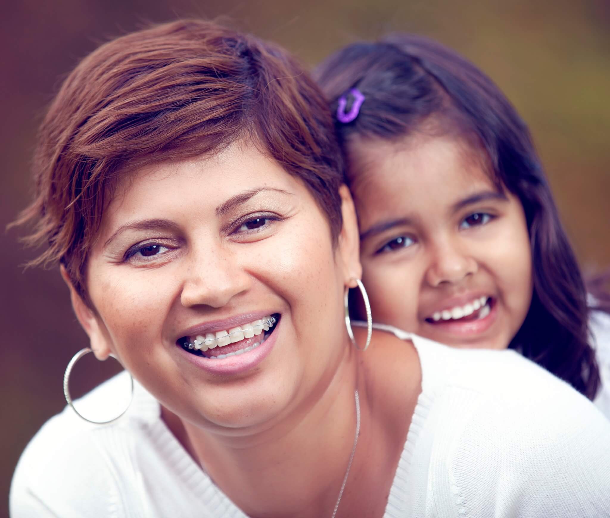 Adult braces, mother wearing ceramic braces and smiling