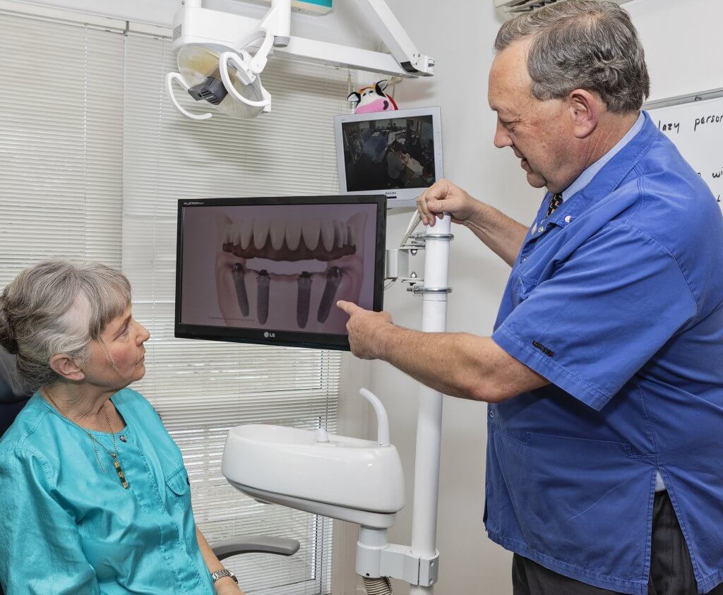 questions to ask before getting a dental implant, patient and implant dentist