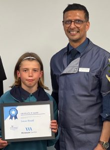 Lucas Braid holding his Orthodontic Scholarship certificate