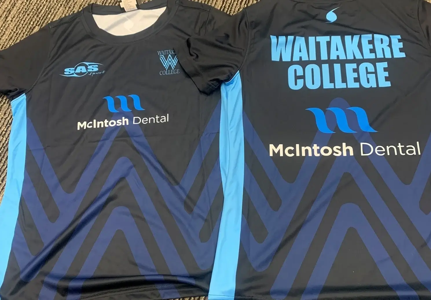 Waitakere College netball jerseys featuring the McIntosh Dental logo